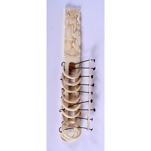 1175 - A 19TH CENTURY CHINESE CARVED CANTON IVORY PUZZLE of figural form. 22.5 cm long.