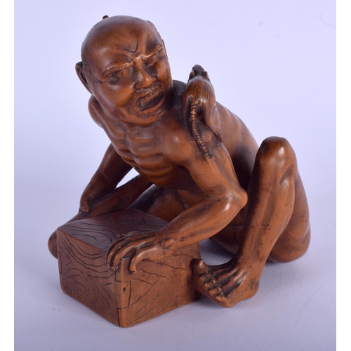 1177 - A 19TH CENTURY JAPANESE MEIJI PERIOD CARVED BOXWOOD RAT CATCHER modelled scowling upon an upturned b... 