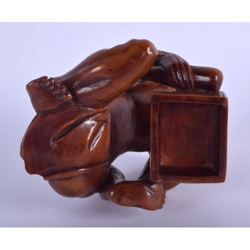 1177 - A 19TH CENTURY JAPANESE MEIJI PERIOD CARVED BOXWOOD RAT CATCHER modelled scowling upon an upturned b... 