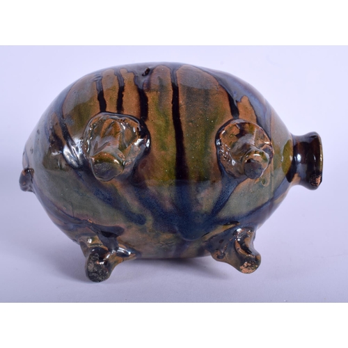 121 - A 19TH CENTURY STAFFORDSHIRE TREACLE GLAZED WHIELDON TYPE MONEY BOX in the form of a pig. 13.5 cm wi... 