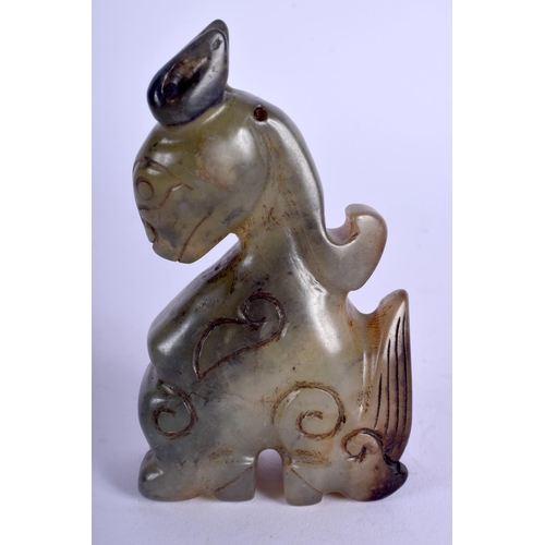 1214 - A CHINESE CARVED JADE FIGURE OF A STYLISED DRAGON 20th Century. 8.5 cm x 6.5 cm.