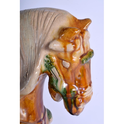 1217 - A LARGE 19TH CENTURY CHINESE SANCAI GLAZED POTTERY FIGURE OF A HORSE Tang Style, modelled upon a sha... 