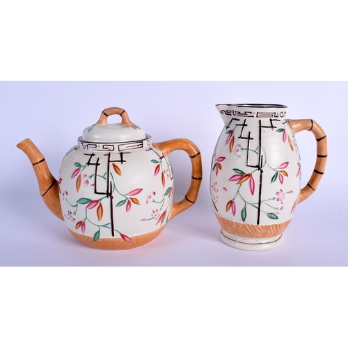 122 - A 19TH CENTURY ENGLISH AESTHETIC MOVEMENT POTTERY TEAPOT together with a cream jug. 21 cm x 16 cm. (... 