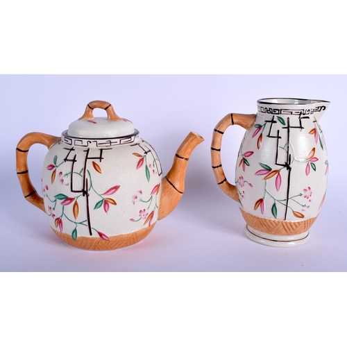 122 - A 19TH CENTURY ENGLISH AESTHETIC MOVEMENT POTTERY TEAPOT together with a cream jug. 21 cm x 16 cm. (... 