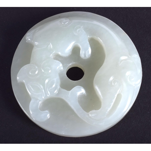 1249 - AN EARLY 20TH CENTURY CHINESE CARVED GREEN JADE CHILONG DISC Late Qing/Republic. 4.25 cm diameter.