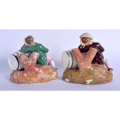 64 - A RARE PAIR OF 19TH CENTURY ENGLISH PORCELAIN FIGURES modelled as two drunken males upon barrels. 8 ... 