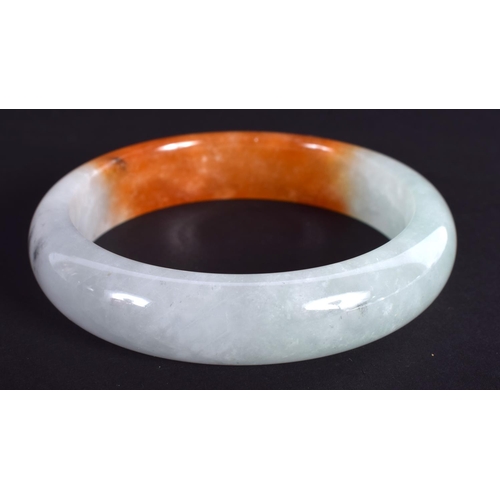 1282 - A CHINESE CARVED TRI COLOUR JADEITE BANGLE 20th Century. 7 cm diameter.