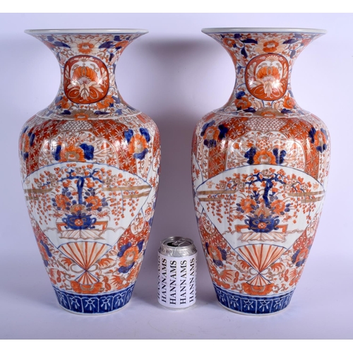 1301 - A LARGE PAIR OF 19TH CENTURY JAPANESE MEIJI PERIOD RIBBED IMARI VASES painted with flowers. 45 cm hi... 