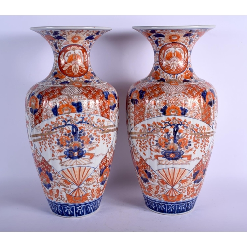 1301 - A LARGE PAIR OF 19TH CENTURY JAPANESE MEIJI PERIOD RIBBED IMARI VASES painted with flowers. 45 cm hi... 