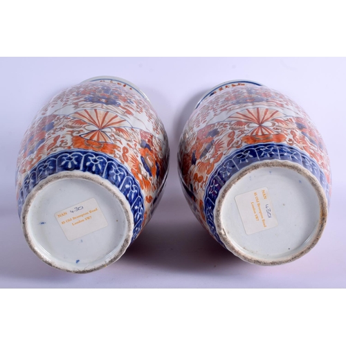 1301 - A LARGE PAIR OF 19TH CENTURY JAPANESE MEIJI PERIOD RIBBED IMARI VASES painted with flowers. 45 cm hi... 