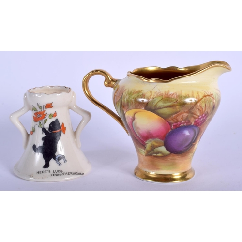 133 - AN AYNSLEY FRUIT PAINTED CREAM JUG together with a crested ware black cat vase. Largest 10 cm wide. ... 