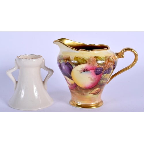 133 - AN AYNSLEY FRUIT PAINTED CREAM JUG together with a crested ware black cat vase. Largest 10 cm wide. ... 