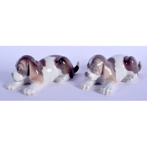 134 - A PAIR OF LLADRO PORCELAIN FIGURES OF SLEEPING HOUNDS. 15 cm wide.