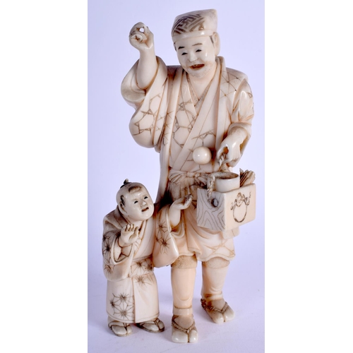 1341 - A 19TH CENTURY JAPANESE MEIJI PERIOD CARVED IVORY OKIMONO modelled as male and child. 14 cm high.