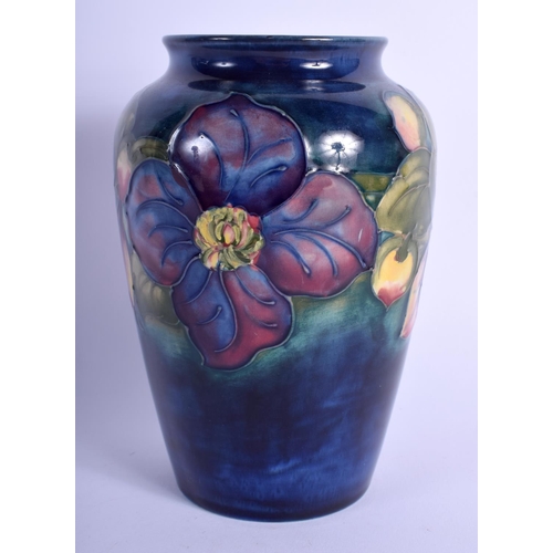 82 - A WILLIAM MOORCROFT VASE painted with foliage. 16 cm high.