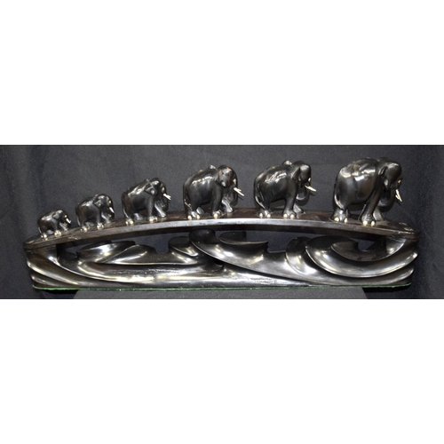 3043 - Ebony carving of elephants crossing a bridge.  20cm x 64cm