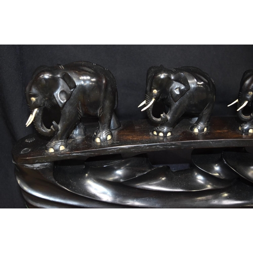 3043 - Ebony carving of elephants crossing a bridge.  20cm x 64cm