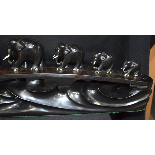 3043 - Ebony carving of elephants crossing a bridge.  20cm x 64cm