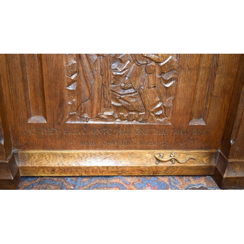 3107 - A small oak Lizard Man Lectern with a fine religious carving to the front.  72cm x 65cm