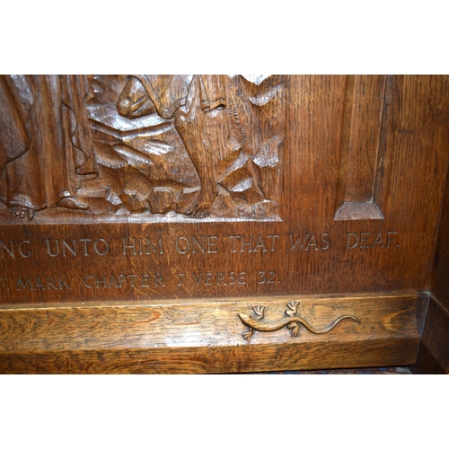 3107 - A small oak Lizard Man Lectern with a fine religious carving to the front.  72cm x 65cm