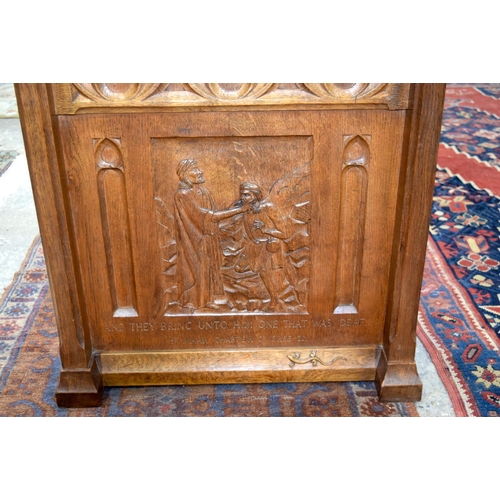 3107 - A small oak Lizard Man Lectern with a fine religious carving to the front.  72cm x 65cm