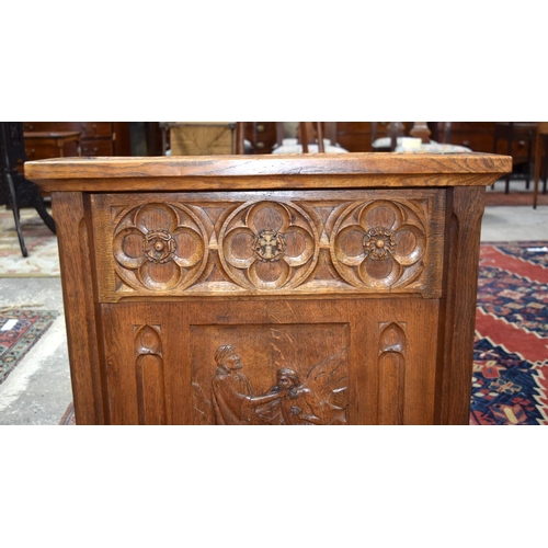 3107 - A small oak Lizard Man Lectern with a fine religious carving to the front.  72cm x 65cm