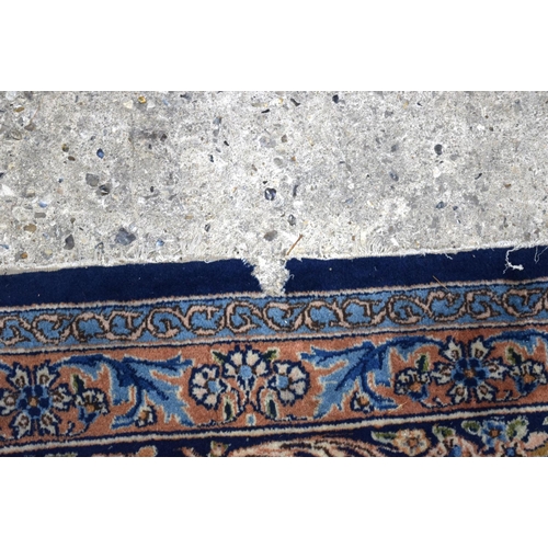 3133 - A Large Persian Blue ground Kirman Rug.  396cm x 304cm