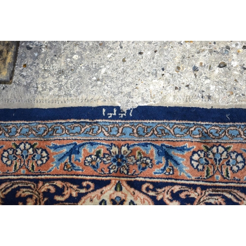 3133 - A Large Persian Blue ground Kirman Rug.  396cm x 304cm