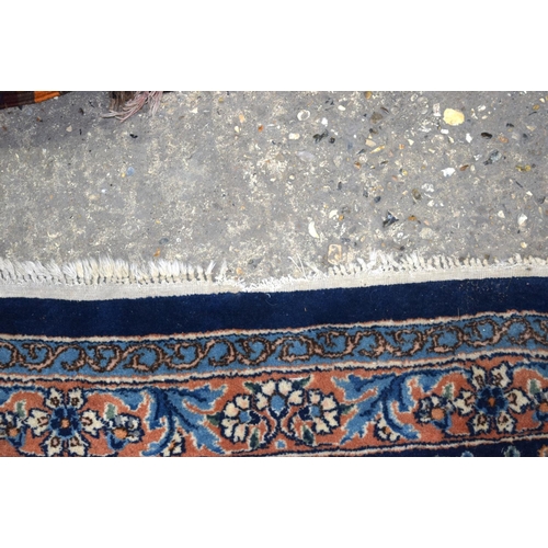 3133 - A Large Persian Blue ground Kirman Rug.  396cm x 304cm