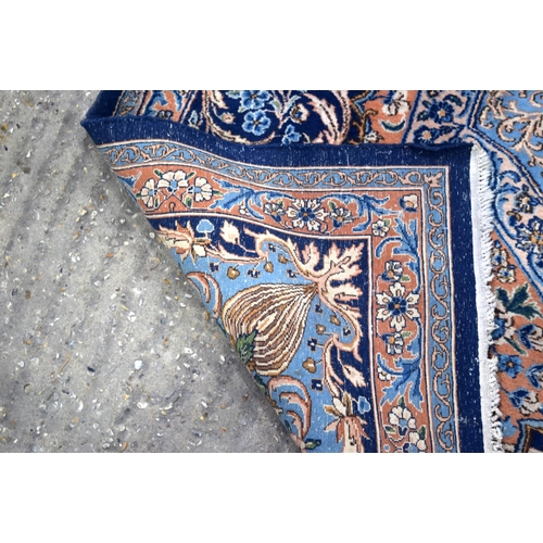 3133 - A Large Persian Blue ground Kirman Rug.  396cm x 304cm