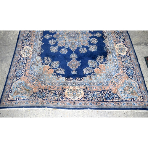 3133 - A Large Persian Blue ground Kirman Rug.  396cm x 304cm