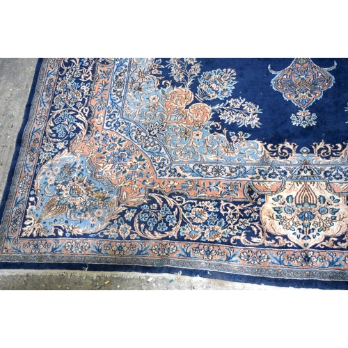 3133 - A Large Persian Blue ground Kirman Rug.  396cm x 304cm