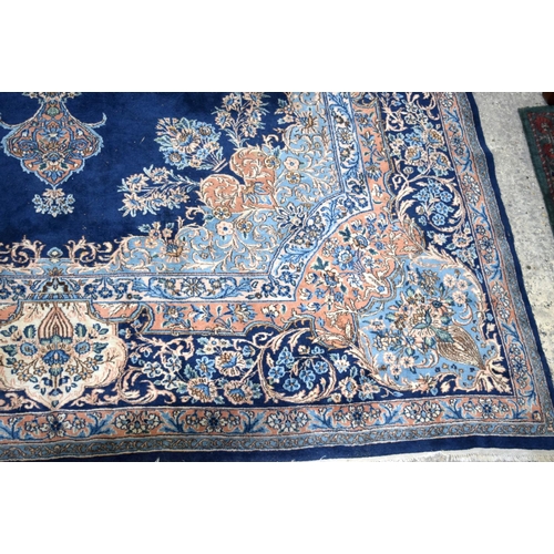 3133 - A Large Persian Blue ground Kirman Rug.  396cm x 304cm