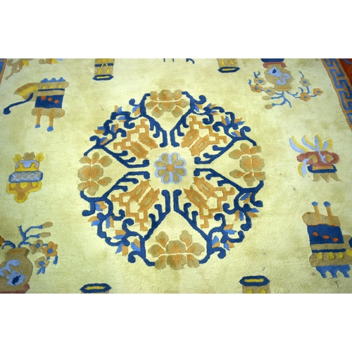 3134 - A Large Yellow ground rug decorated with auspicious symbols.  366cm x 274cm