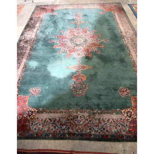 3135 - A Large country house Green Ground Persian rug.  542cm x 367cm