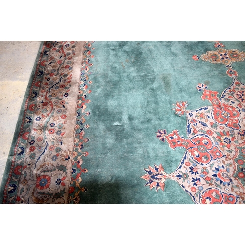 3135 - A Large country house Green Ground Persian rug.  542cm x 367cm