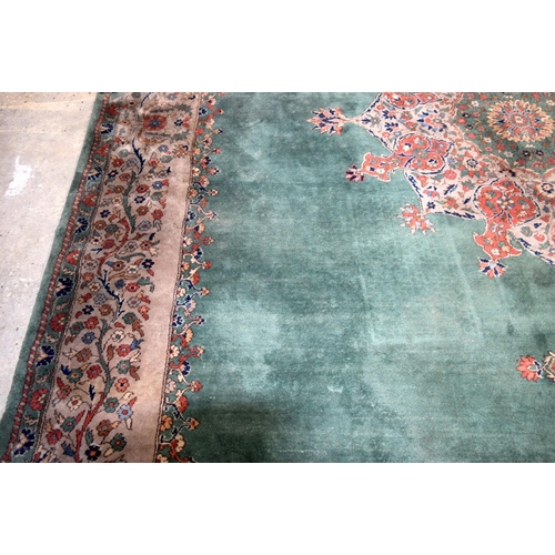 3135 - A Large country house Green Ground Persian rug.  542cm x 367cm