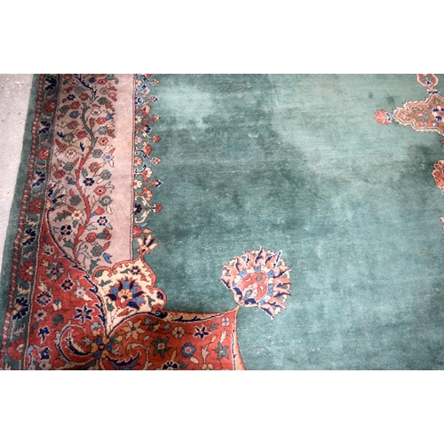 3135 - A Large country house Green Ground Persian rug.  542cm x 367cm