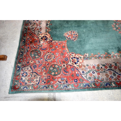 3135 - A Large country house Green Ground Persian rug.  542cm x 367cm