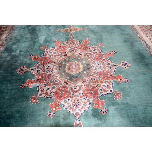 3135 - A Large country house Green Ground Persian rug.  542cm x 367cm