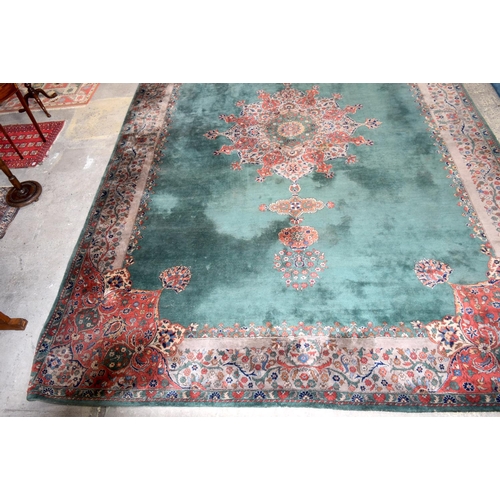 3135 - A Large country house Green Ground Persian rug.  542cm x 367cm