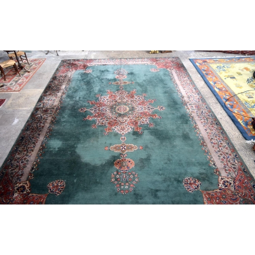 3135 - A Large country house Green Ground Persian rug.  542cm x 367cm