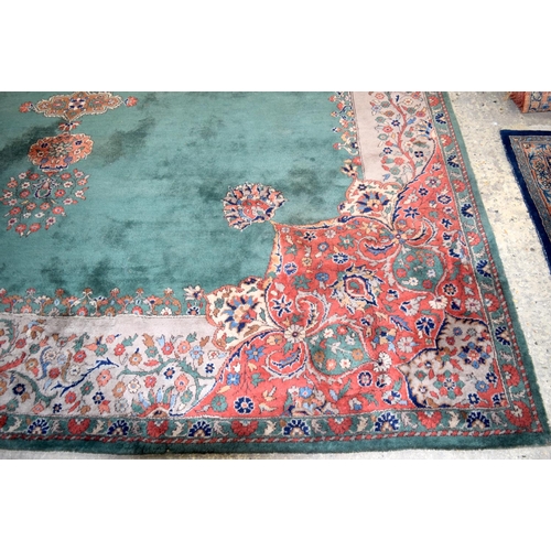 3135 - A Large country house Green Ground Persian rug.  542cm x 367cm