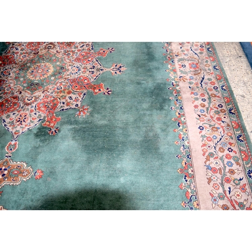 3135 - A Large country house Green Ground Persian rug.  542cm x 367cm