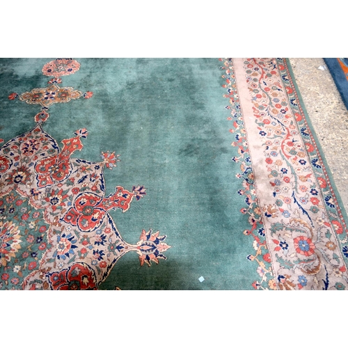 3135 - A Large country house Green Ground Persian rug.  542cm x 367cm