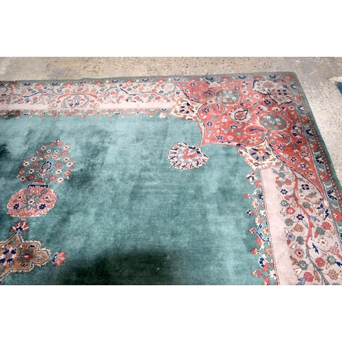 3135 - A Large country house Green Ground Persian rug.  542cm x 367cm