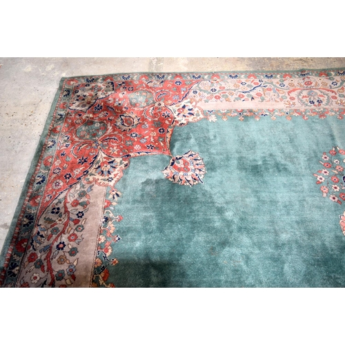 3135 - A Large country house Green Ground Persian rug.  542cm x 367cm