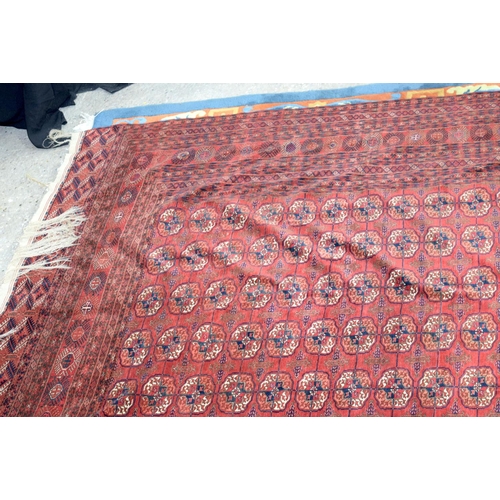 3136 - A Large red ground Oriental rug.  350cm x 250cm