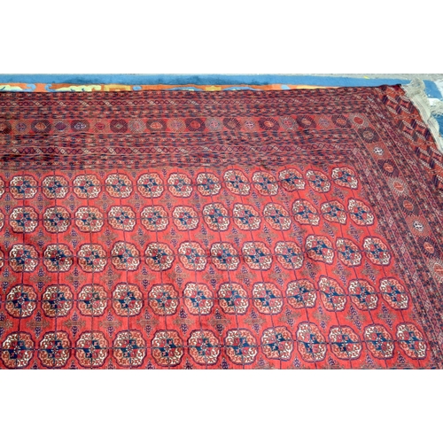 3136 - A Large red ground Oriental rug.  350cm x 250cm