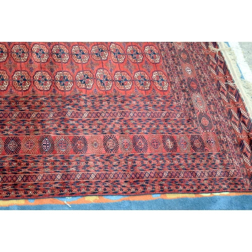 3136 - A Large red ground Oriental rug.  350cm x 250cm